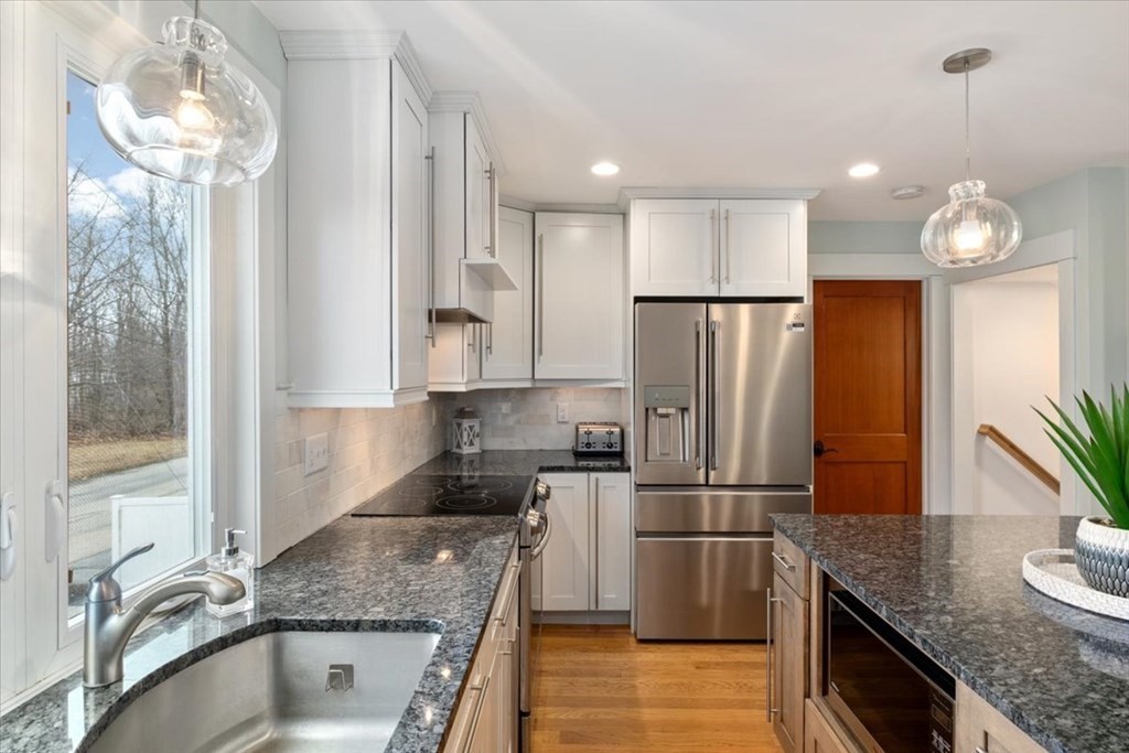 20 Bates Point Road Webster, MA 01570 - Photo 12 of 32 a kitchen with granite countertop a refrigerator a stove and a sink with wooden floor