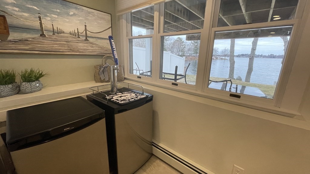 20 Bates Point Road Webster, MA 01570 - Photo 22 of 32 a table with a sink and a potted plant next to a window