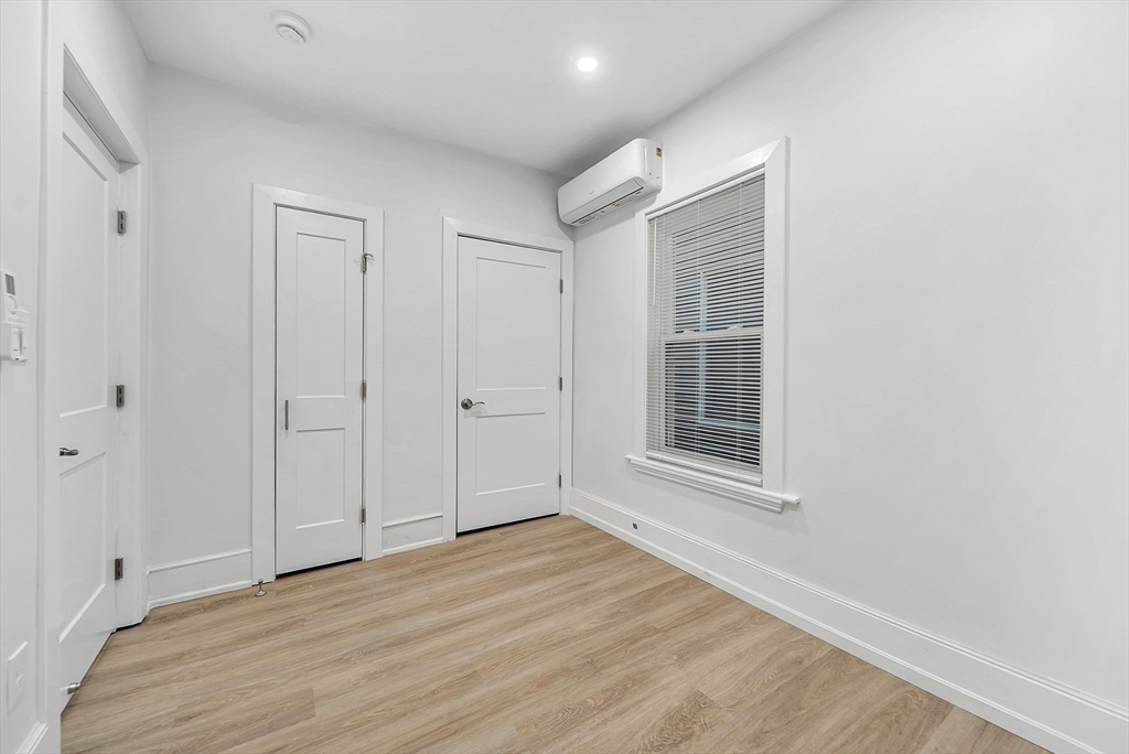 92 Willow Street, Unit 2 Cambridge, MA 02141 - Photo 12 of 20 a view of an empty room with wooden floor and a window