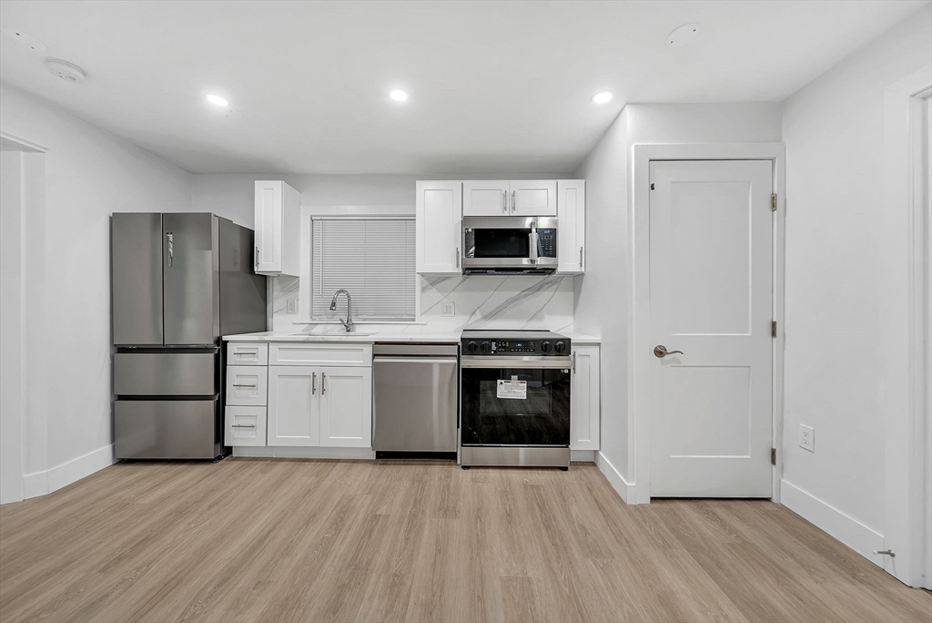92 Willow Street, Unit 2 Cambridge, MA 02141 - Photo 4 of 20 a kitchen with a refrigerator and a stove top oven