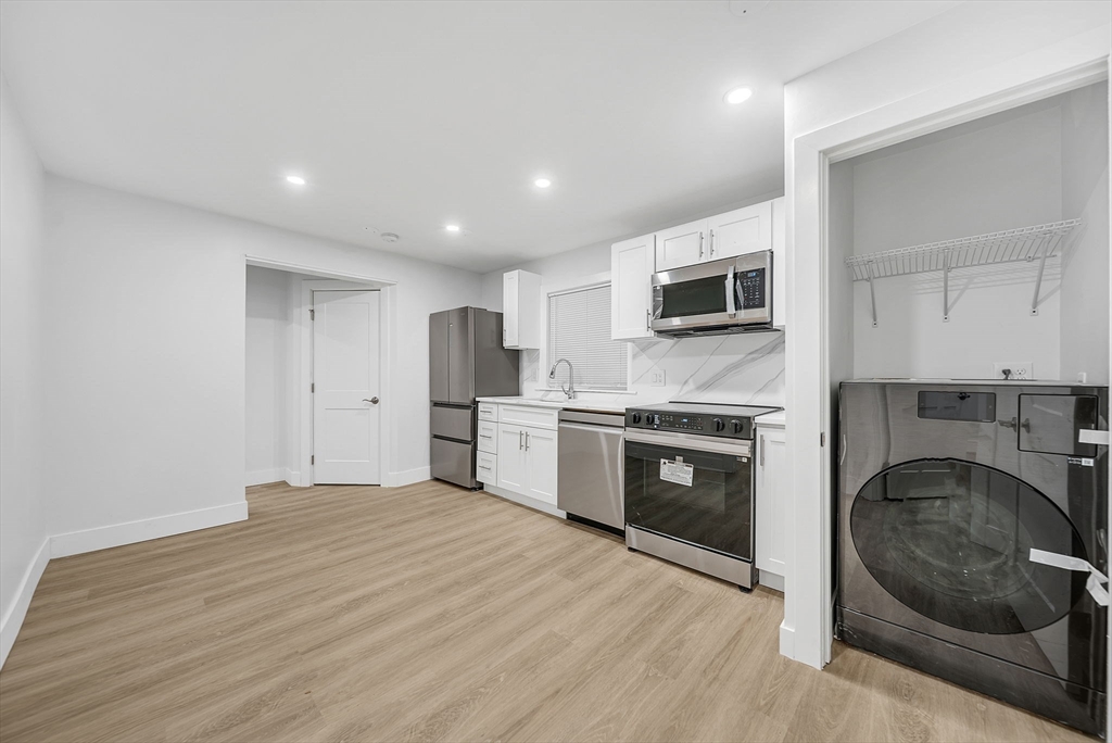 92 Willow Street, Unit 2 Cambridge, MA 02141 - Photo 5 of 20 a large kitchen with stainless steel appliances granite countertop a stove and a sink