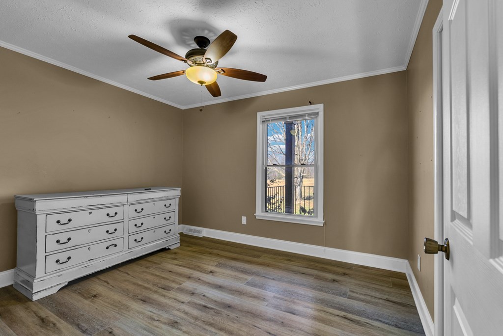 1868 Herbert Garrett Road Cookeville, TN 38506 - Photo 15 of 47 a view of an empty room with wooden floor and a window