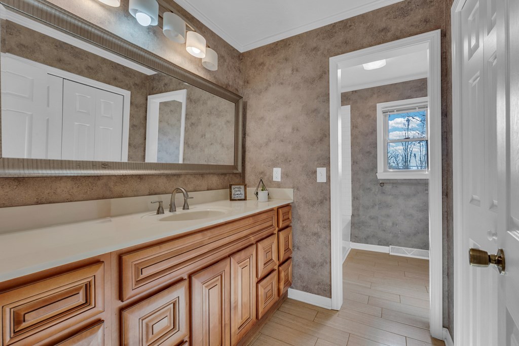 1868 Herbert Garrett Road Cookeville, TN 38506 - Photo 19 of 47 a bathroom with a sink a vanity and a mirror
