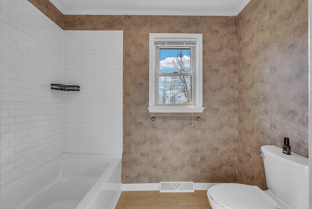 1868 Herbert Garrett Road Cookeville, TN 38506 - Photo 20 of 47 a white toilet sitting next to a bath tub and shower