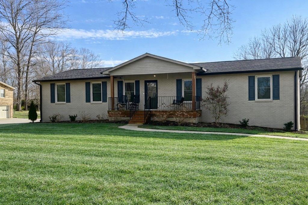 1868 Herbert Garrett Road Cookeville, TN 38506 - Photo 2 of 47 a front view of a house with a garden