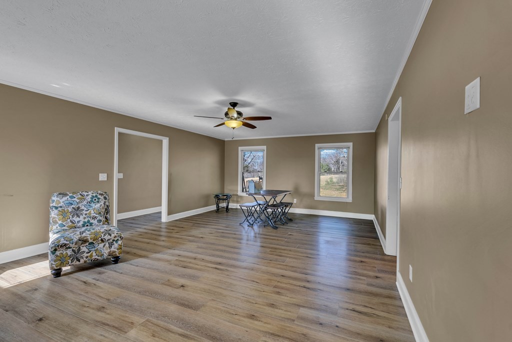 1868 Herbert Garrett Road Cookeville, TN 38506 - Photo 28 of 47 a view of empty room with wooden floor and chandelier