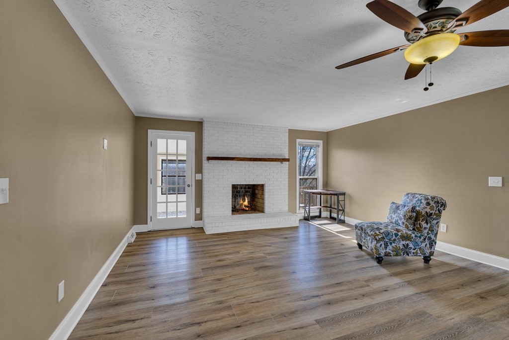 1868 Herbert Garrett Road Cookeville, TN 38506 - Photo 29 of 47 a view of empty room with wooden floor and fireplace