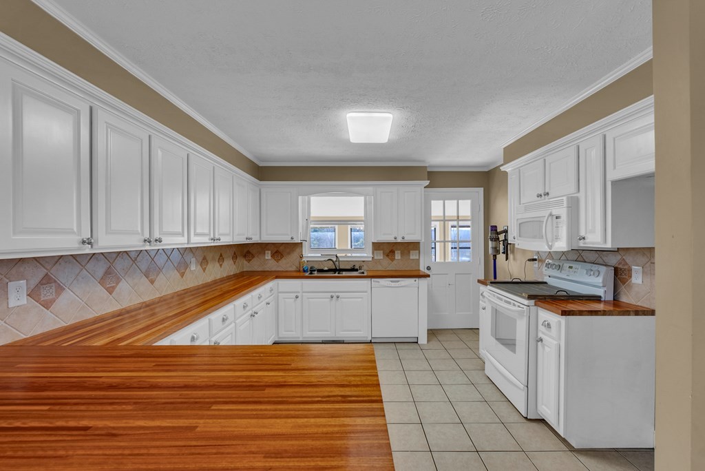 1868 Herbert Garrett Road Cookeville, TN 38506 - Photo 9 of 47 a kitchen with stainless steel appliances granite countertop a sink and cabinets