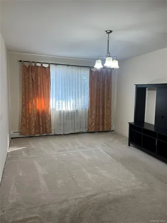 en empty room with windows and furniture