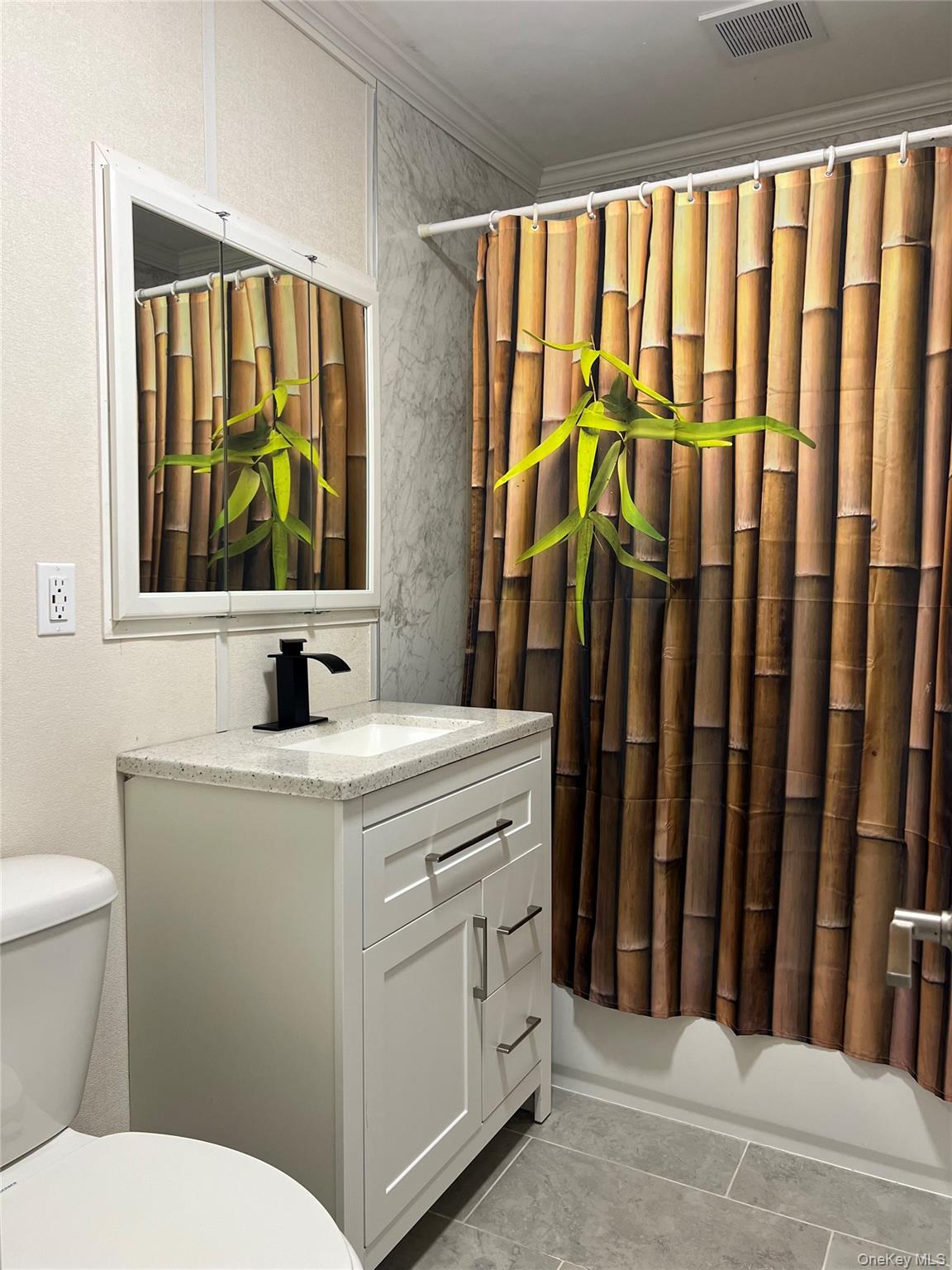 2 Secora Road, Unit 16 Monsey, NY 10952 - Photo 13 of 15 Renovated bathroom with new vanity, countertop, and ceramic tile floor