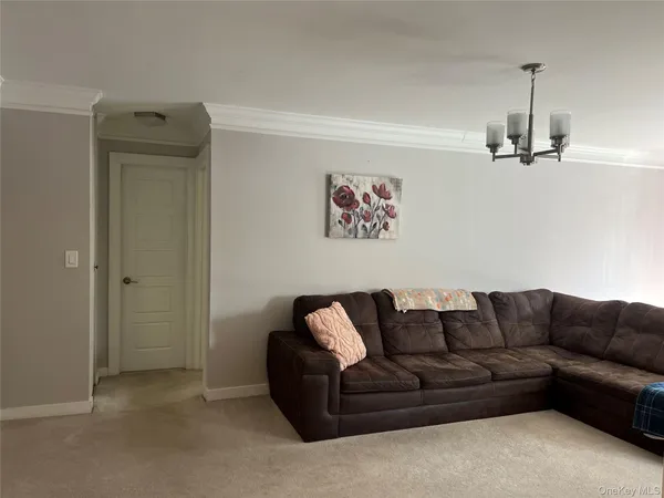 a living room with furniture and a ceiling fan