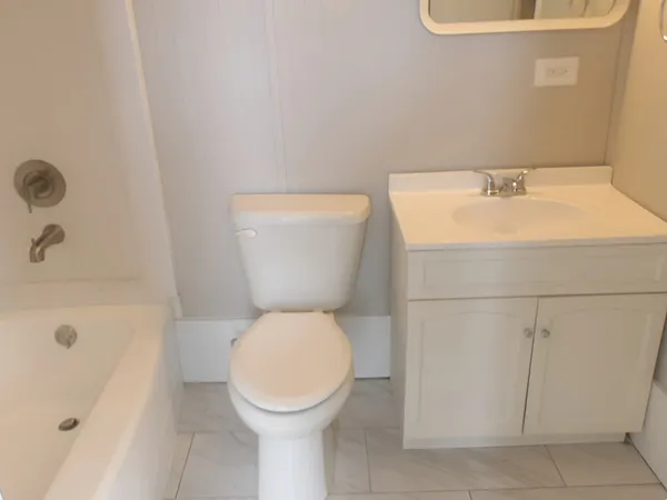 a white toilet sitting next to a bathroom sink
