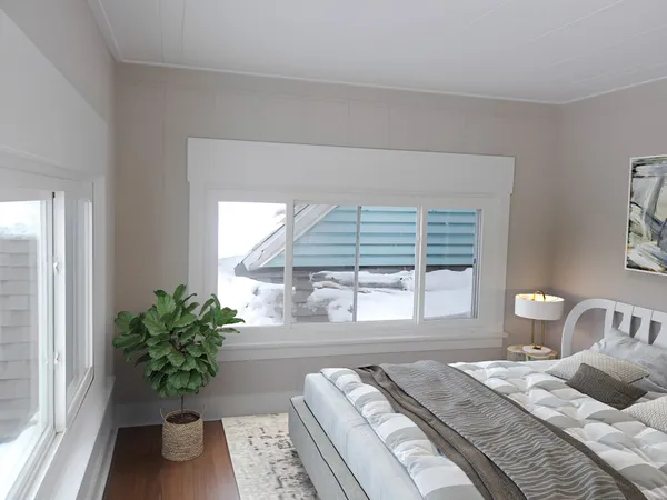 a bedroom with a bed table flowerpot and window