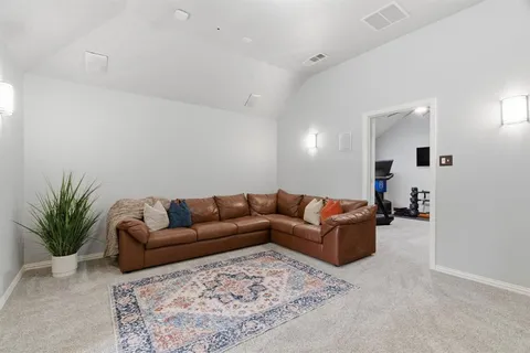 a living room with furniture and a potted plant
