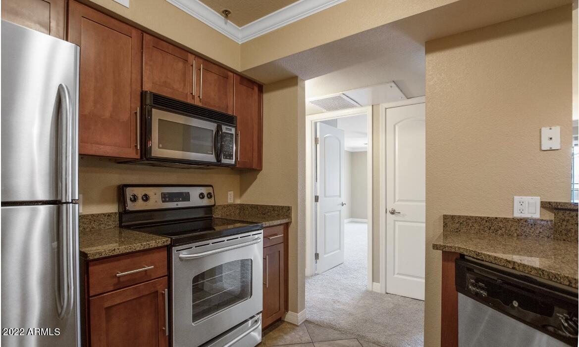 2025 East Campbell Avenue, Unit 156 Phoenix, AZ 85016 - Photo 5 of 23 a kitchen with stainless steel appliances granite countertop a refrigerator stove and microwave