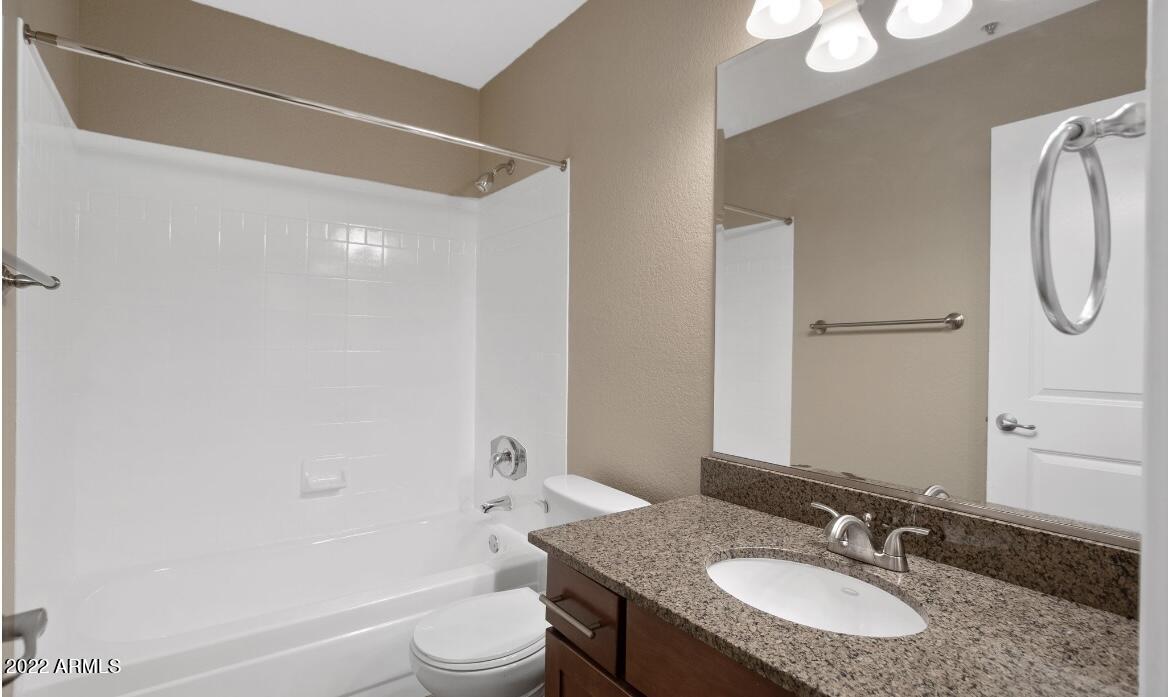 2025 East Campbell Avenue, Unit 156 Phoenix, AZ 85016 - Photo 9 of 23 a bathroom with a granite countertop sink toilet and shower