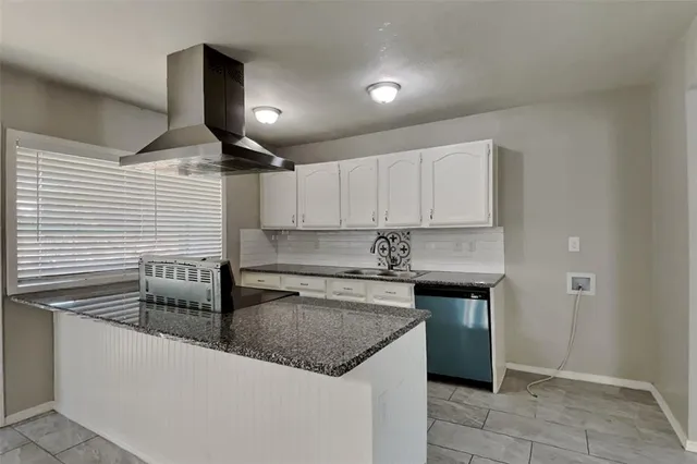 a kitchen with stainless steel appliances granite countertop a sink and a refrigerator