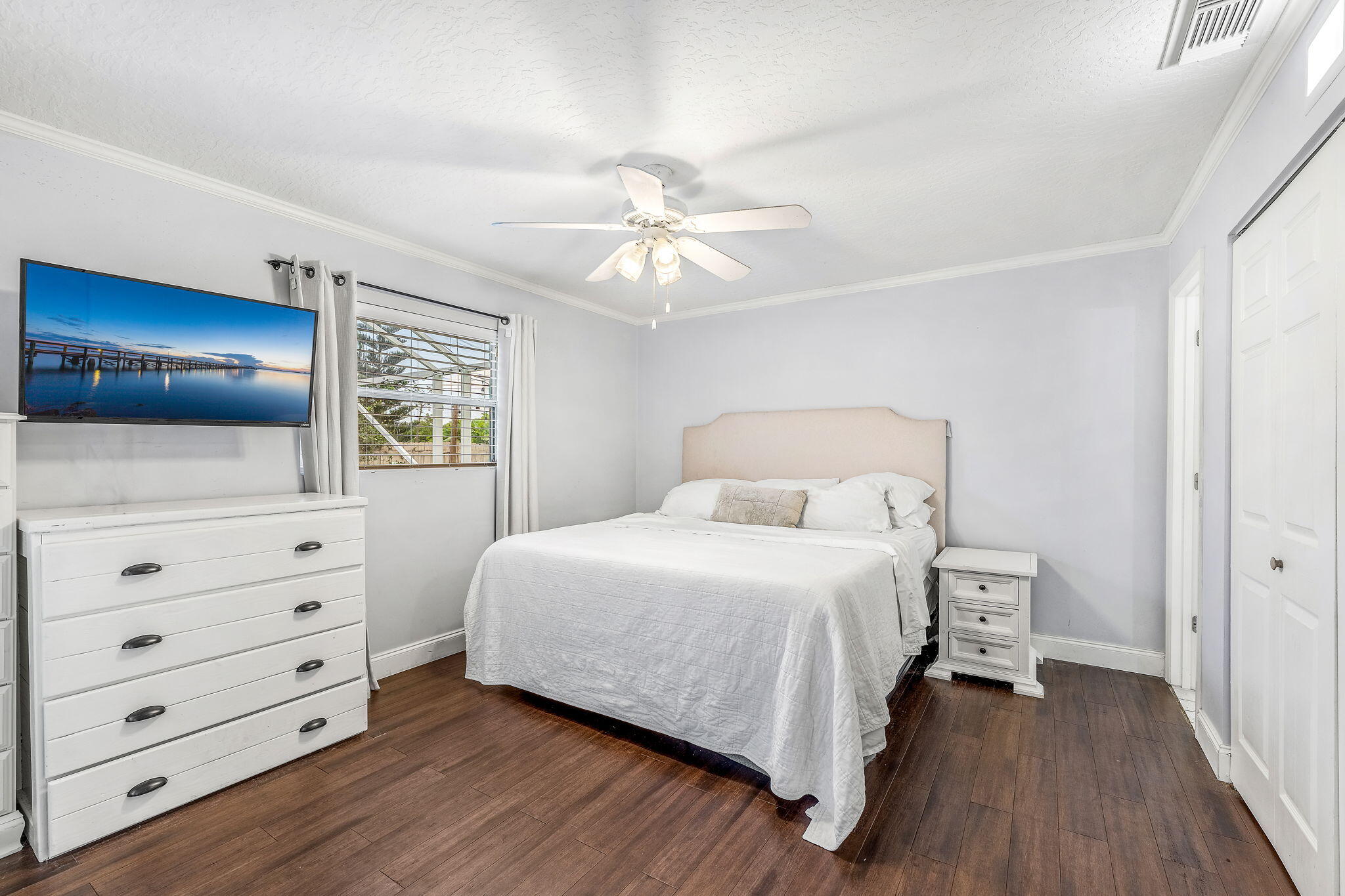 680 Mark Drive Melbourne, FL 32904 - Photo 12 of 36 a bedroom with a bed and painting on the wall