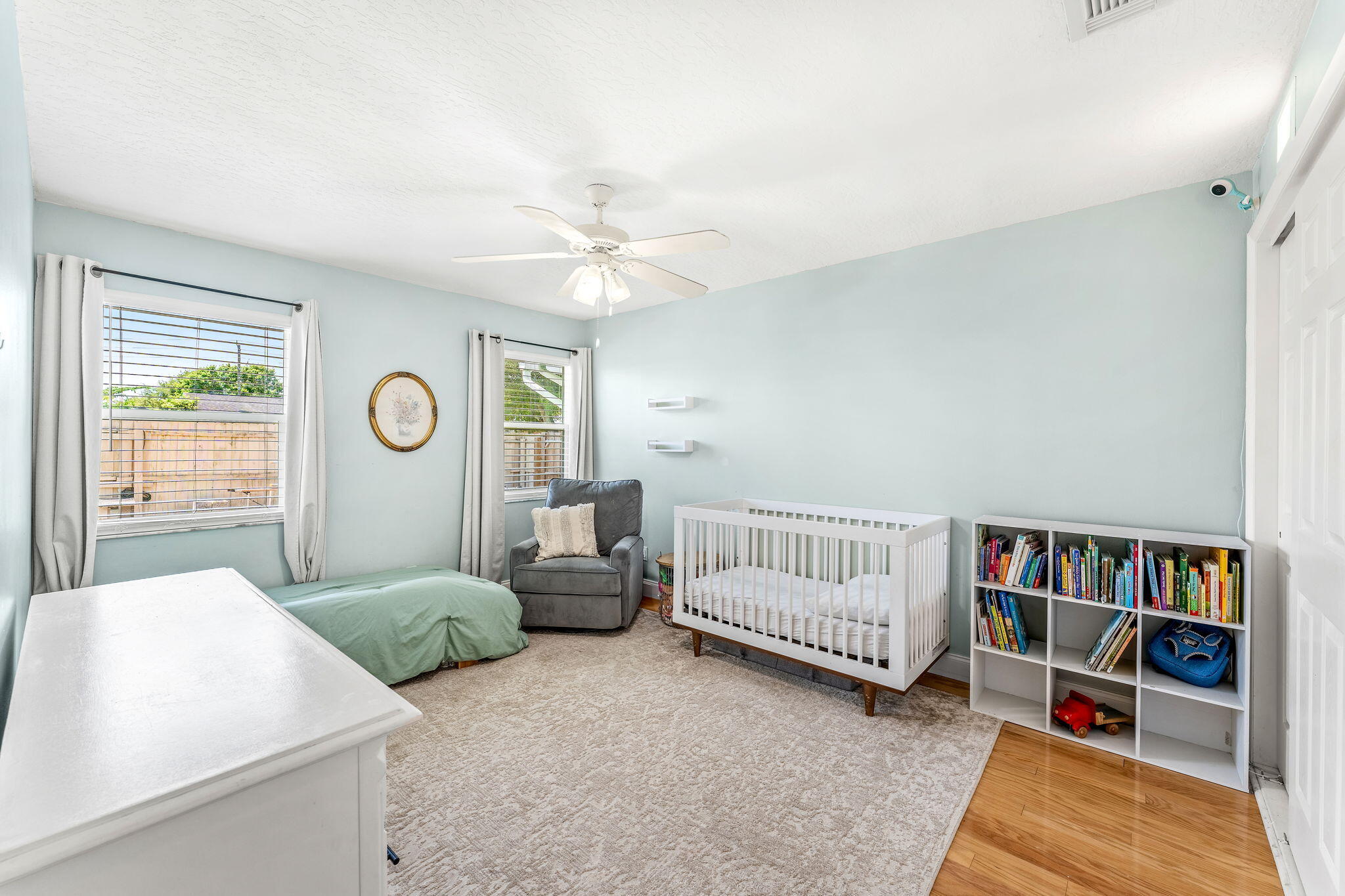 680 Mark Drive Melbourne, FL 32904 - Photo 14 of 36 a spacious bedroom with a bed and a book shelf