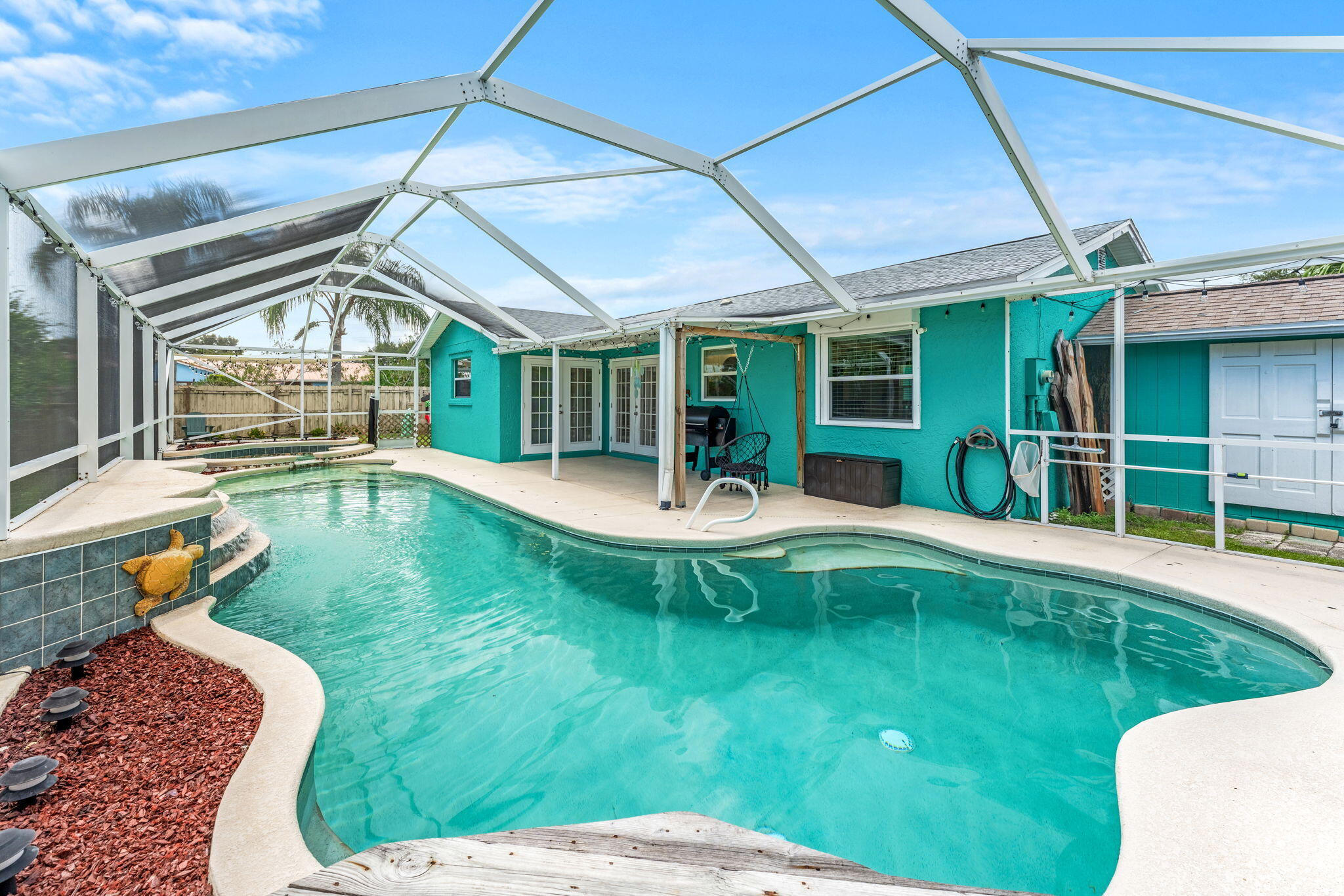 680 Mark Drive Melbourne, FL 32904 - Photo 16 of 36 a view of a house with a backyard patio and swimming pool