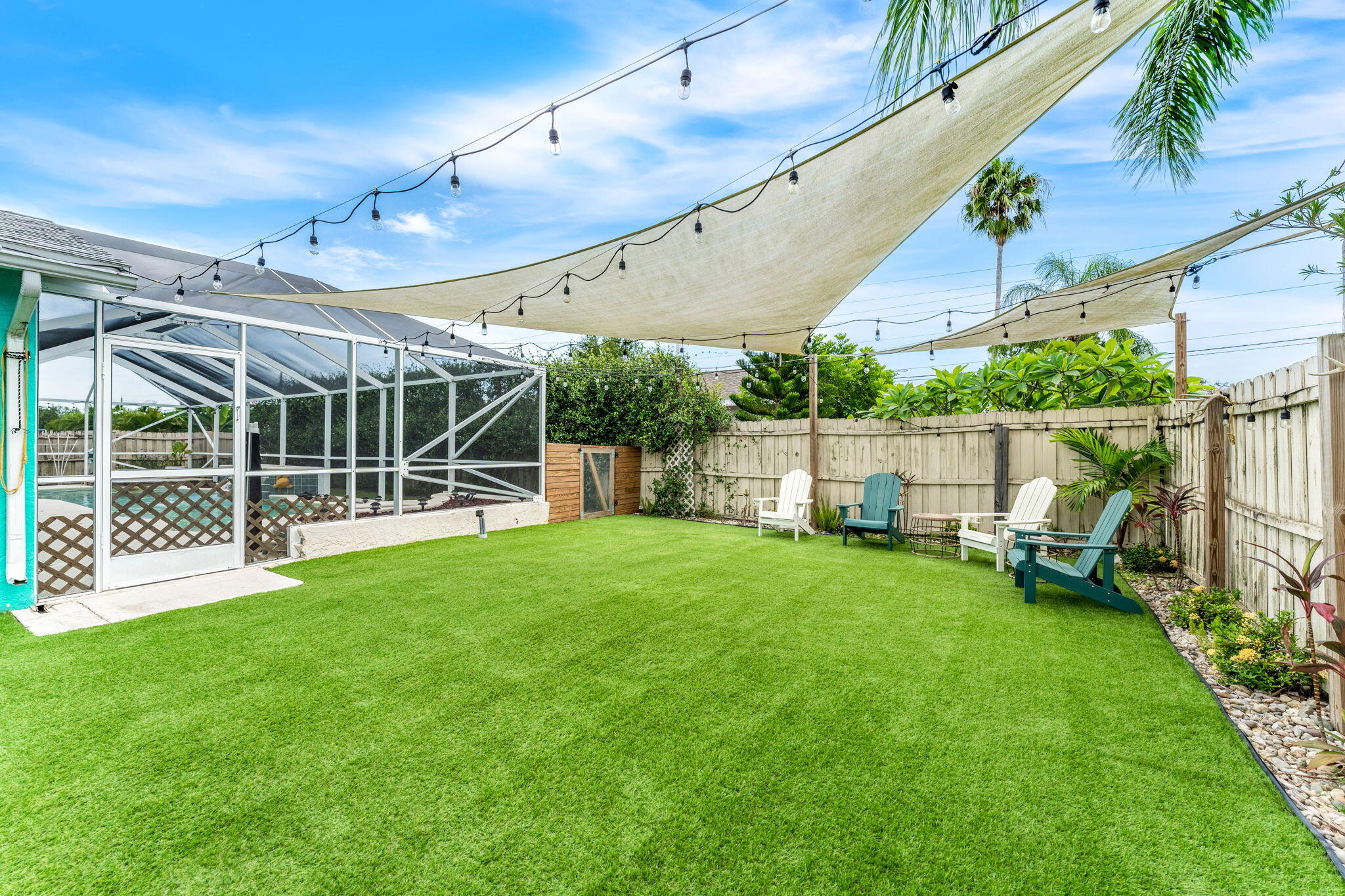 680 Mark Drive Melbourne, FL 32904 - Photo 21 of 36 a view of a yard with a deck and a garden