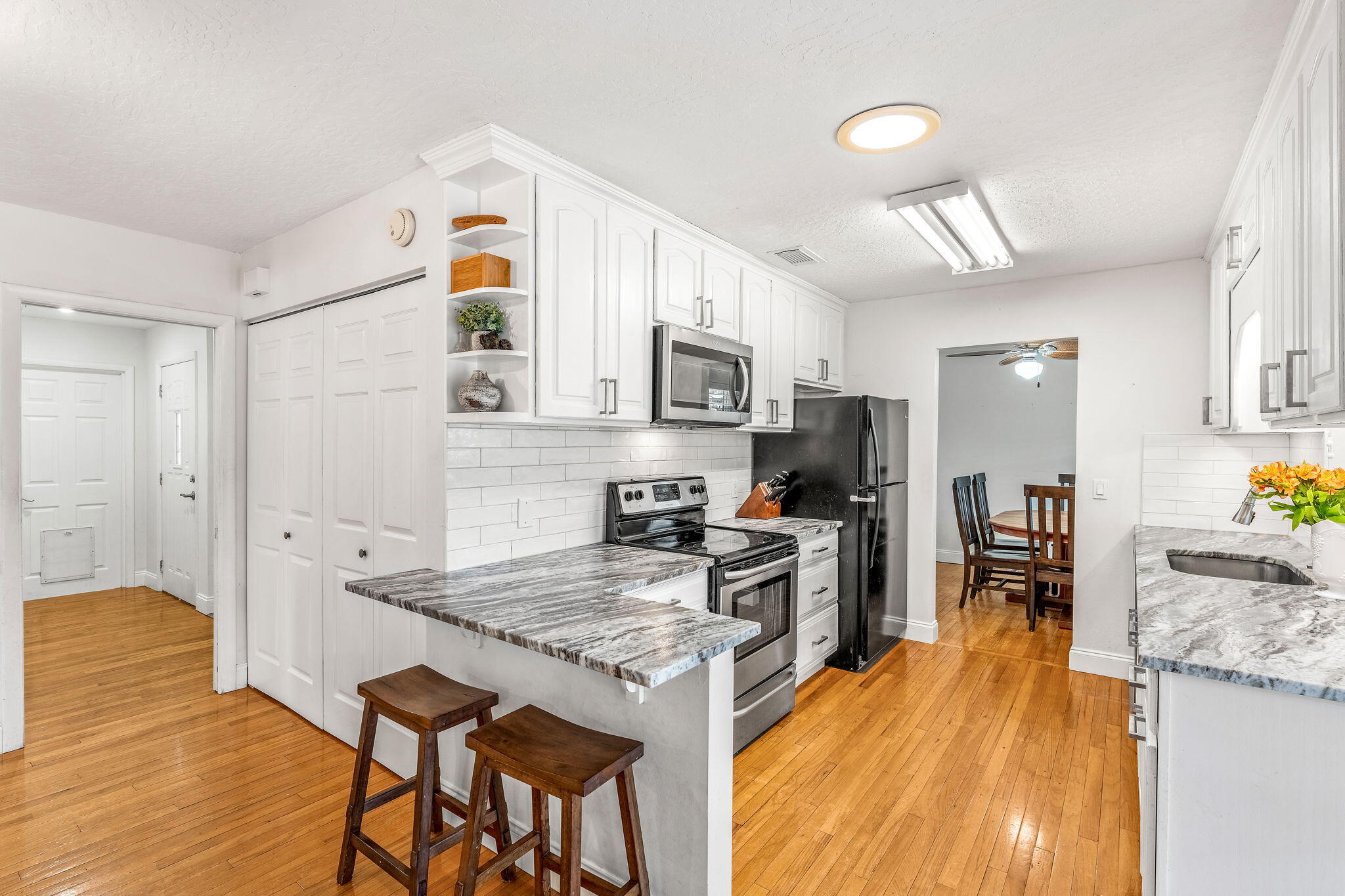680 Mark Drive Melbourne, FL 32904 - Photo 8 of 36 a kitchen with granite countertop kitchen island wooden cabinets and stainless steel appliances