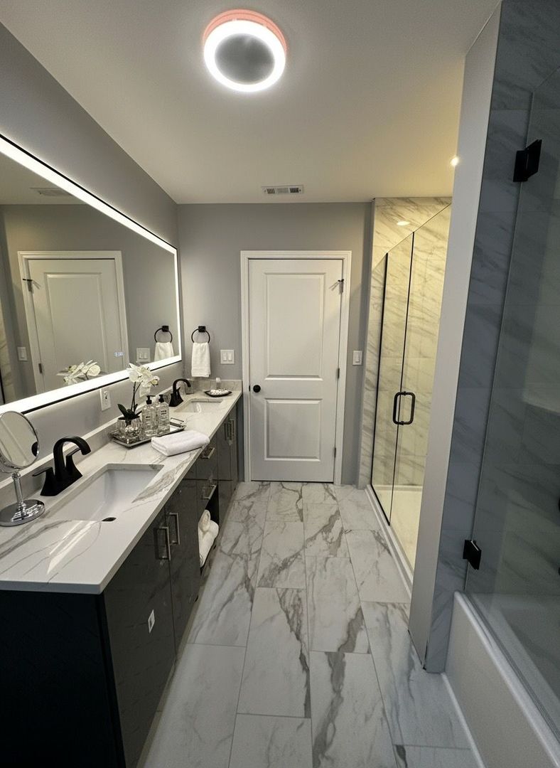 62 West 113th Street Chicago, IL 60628 - Photo 35 of 54 a bathroom with a double vanity sink a mirror and a bathtub