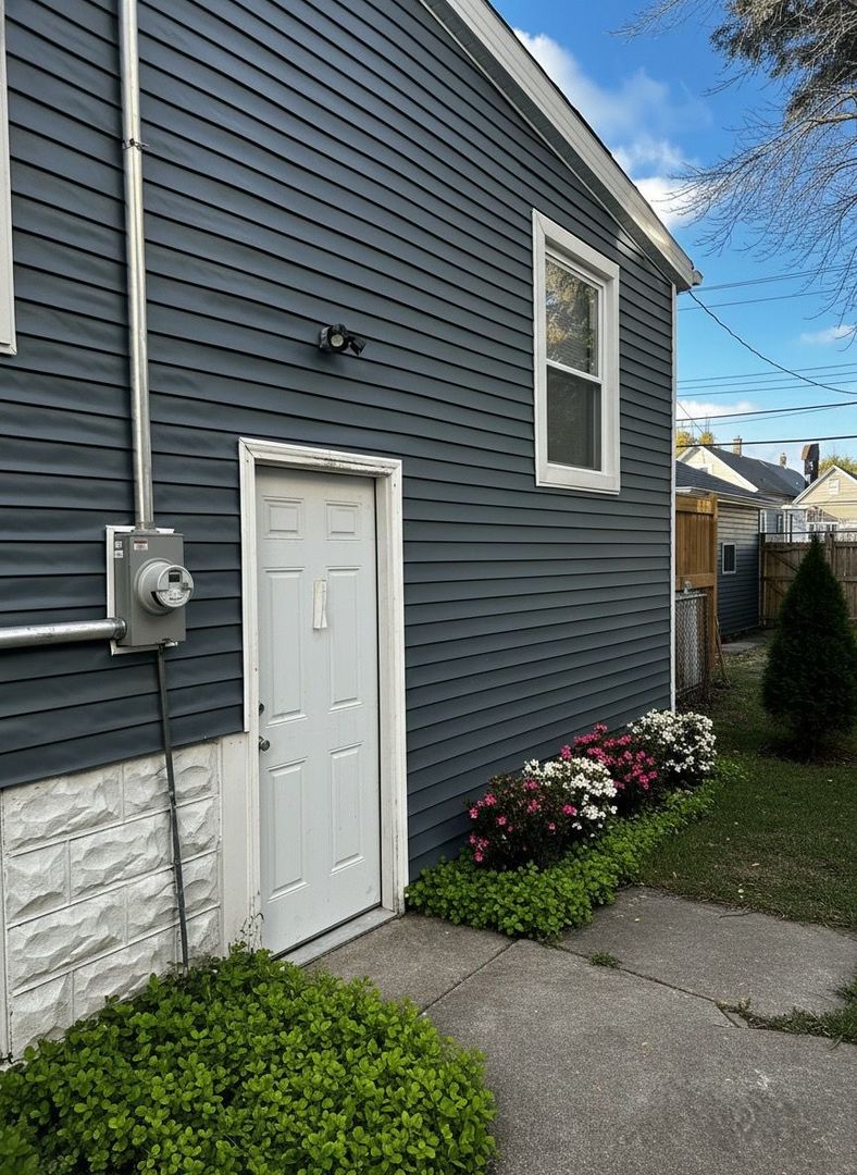 62 West 113th Street Chicago, IL 60628 - Photo 47 of 54 a view of a house with a yard and a garden