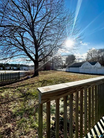 a view of a backyard with wooden fence