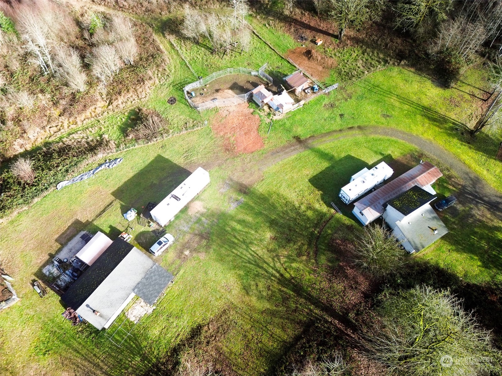 7608 Southwest Scatter View Lane Rochester, WA 98579 - Photo 1 of 23 an aerial view of a house with a yard and lake view