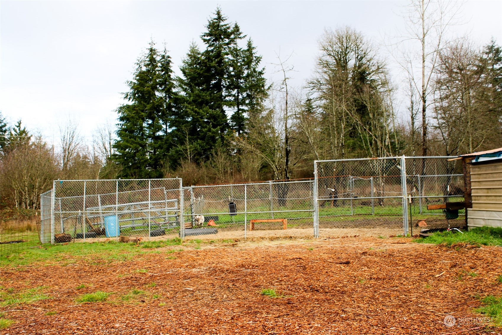 7608 Southwest Scatter View Lane Rochester, WA 98579 - Photo 14 of 23 a view of a yard with wooden fence