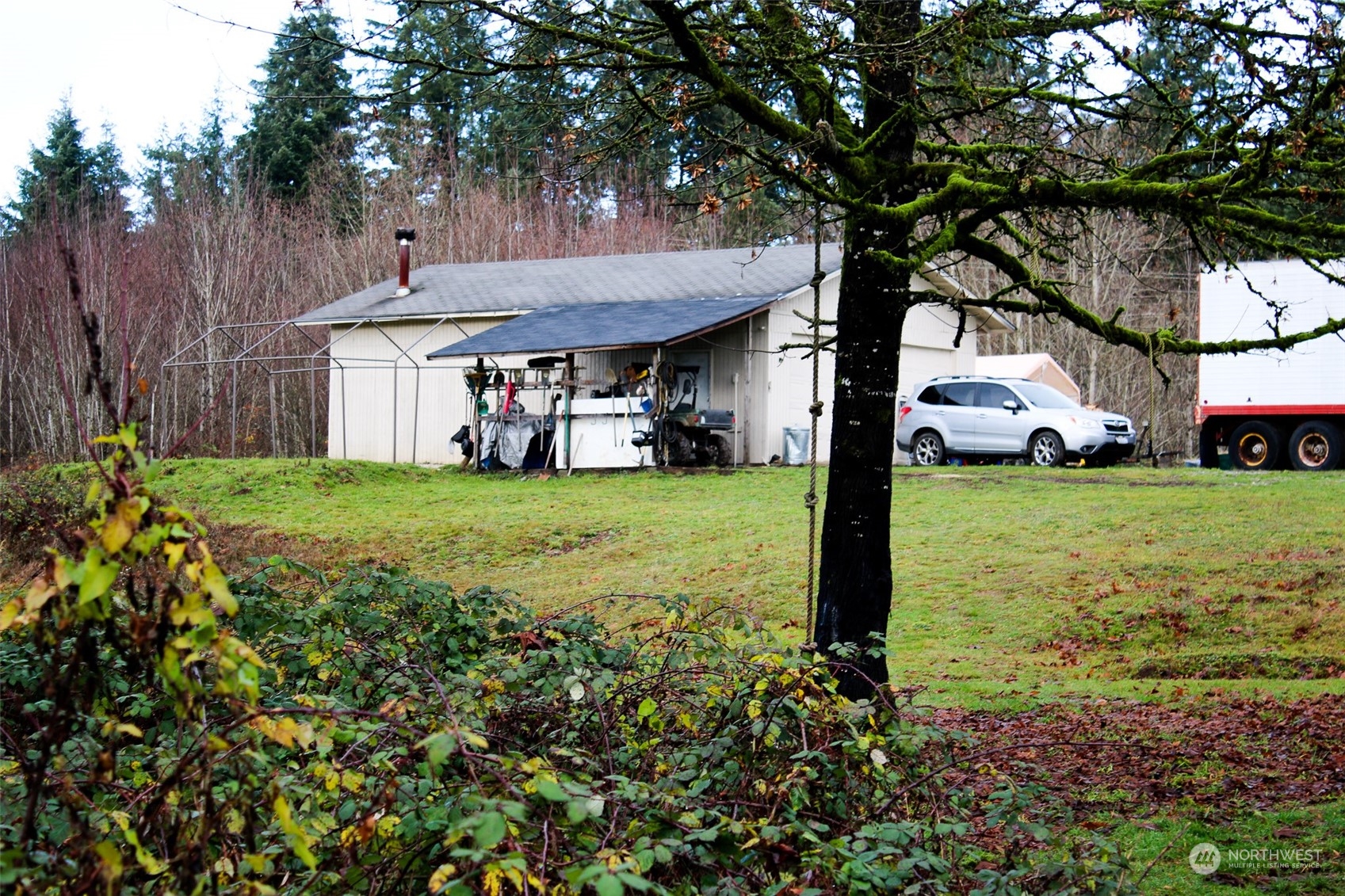7608 Southwest Scatter View Lane Rochester, WA 98579 - Photo 10 of 23 a view of a house with a yard and sitting area