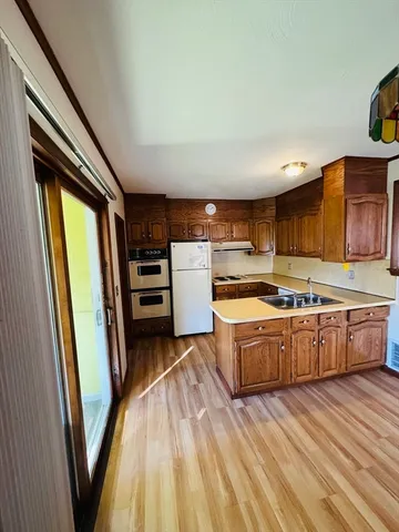 a kitchen with stainless steel appliances granite countertop a refrigerator a stove and a sink with large countertops