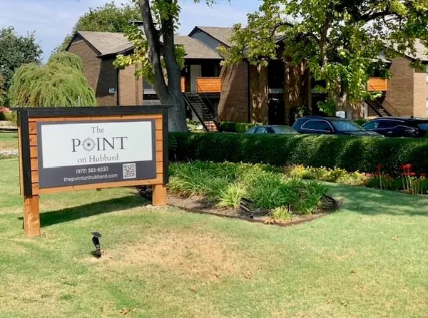 a view of a sign board with big yard