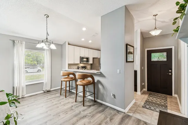 a dining room with furniture and window