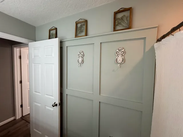 a view of a white house with a yard