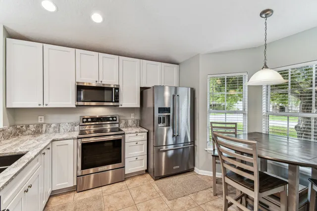a kitchen with stainless steel appliances a stove a sink refrigerator and cabinets