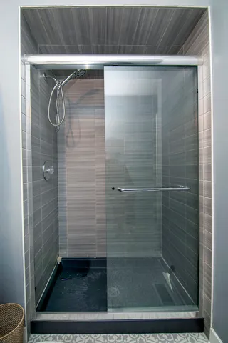 a bathroom with a glass shower door