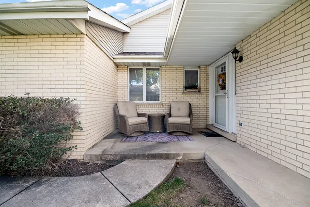 a view of a patio with table and chairs and potted plants