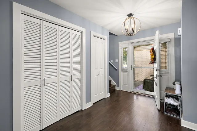 a view of a livingroom with wooden floor and furniture