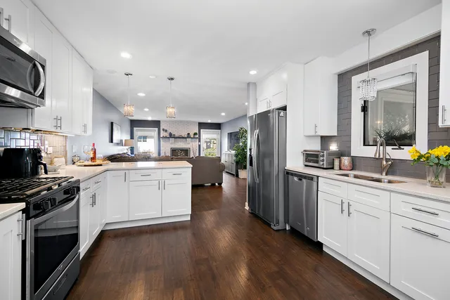 a kitchen with a sink stainless steel appliances and cabinets