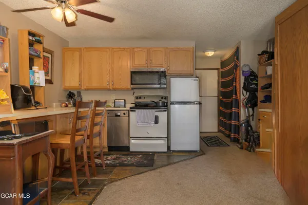 a kitchen with appliances cabinets and a sink