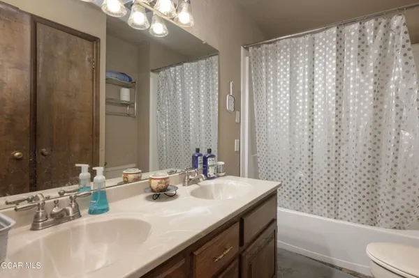 a bathroom with a double vanity sink and a mirror