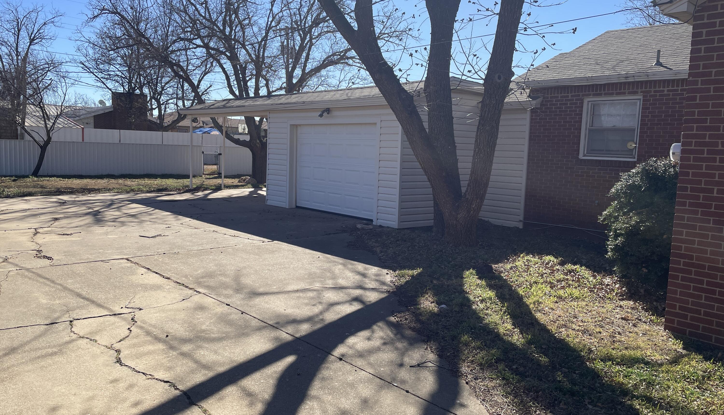 817 North 16th Street Lamesa, TX 79331 - Photo 3 of 12 a view of backyard with large tree