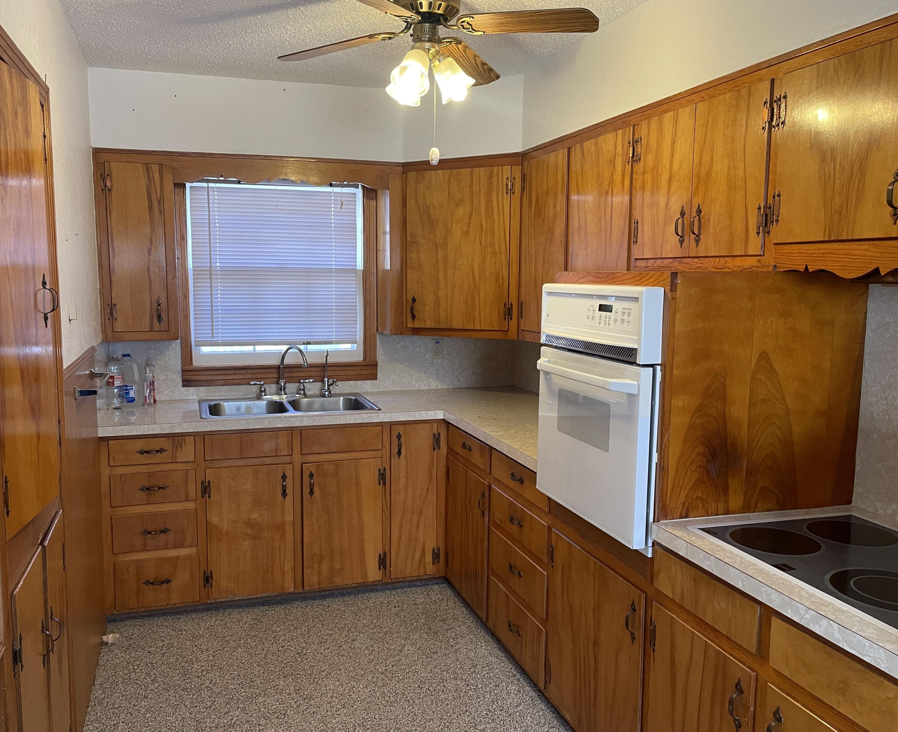 817 North 16th Street Lamesa, TX 79331 - Photo 6 of 12 a kitchen with sink a cabinets and window