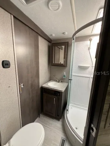 a bathroom with a sink toilet and shower