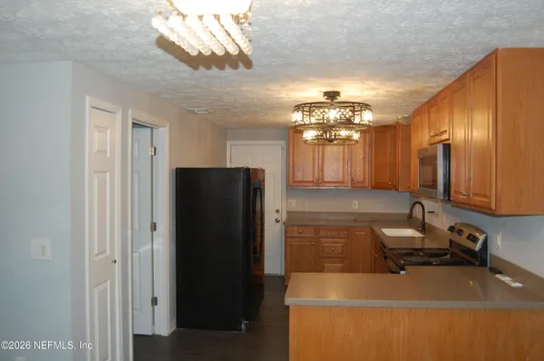 a kitchen with a refrigerator and a sink