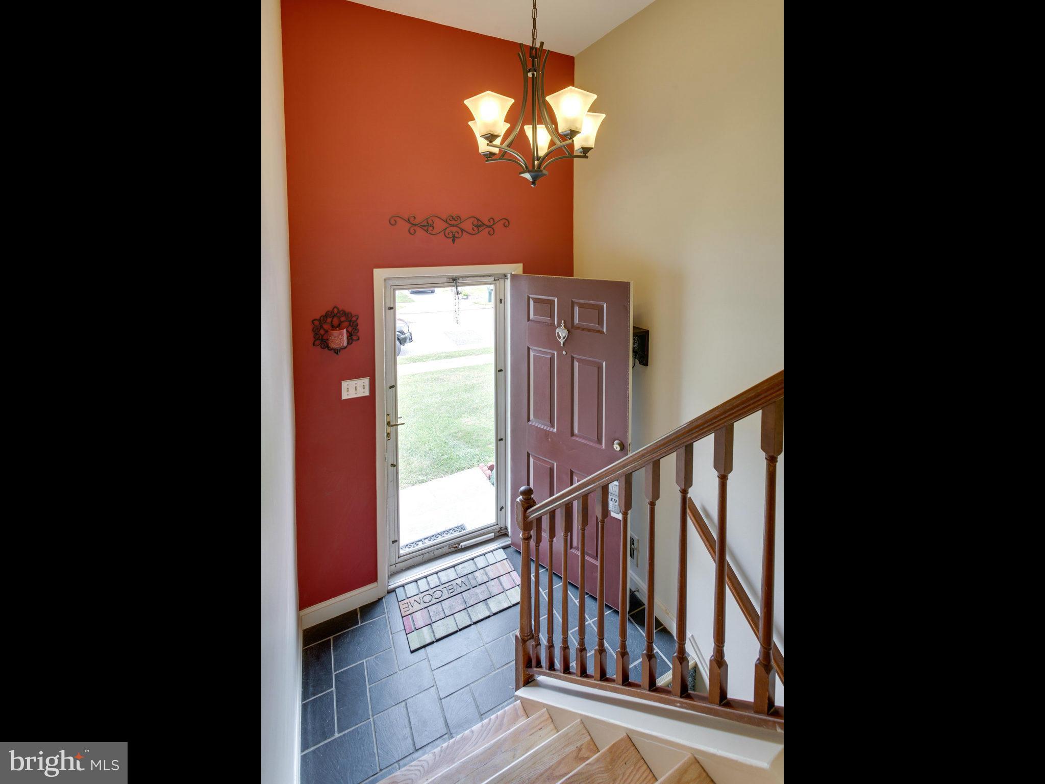 415 Rockway Road Catonsville, MD 21228 - Photo 2 of 30 a view of a hallway with wooden floor and chandelier