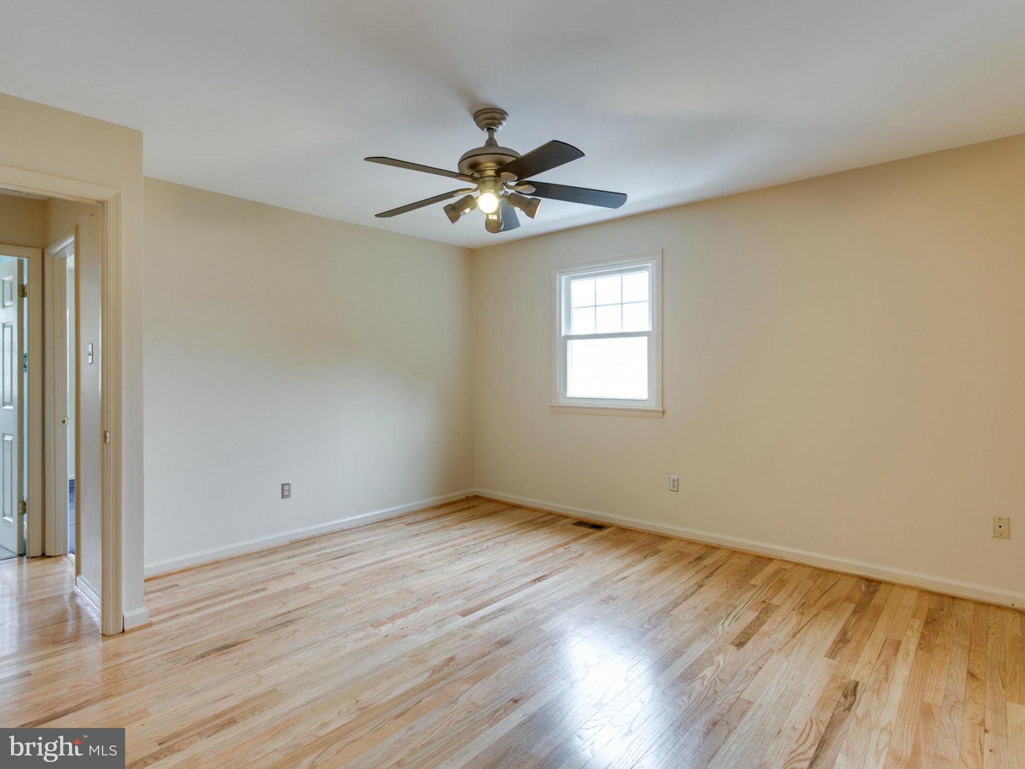 415 Rockway Road Catonsville, MD 21228 - Photo 13 of 30 a view of empty room with wooden floor and fan