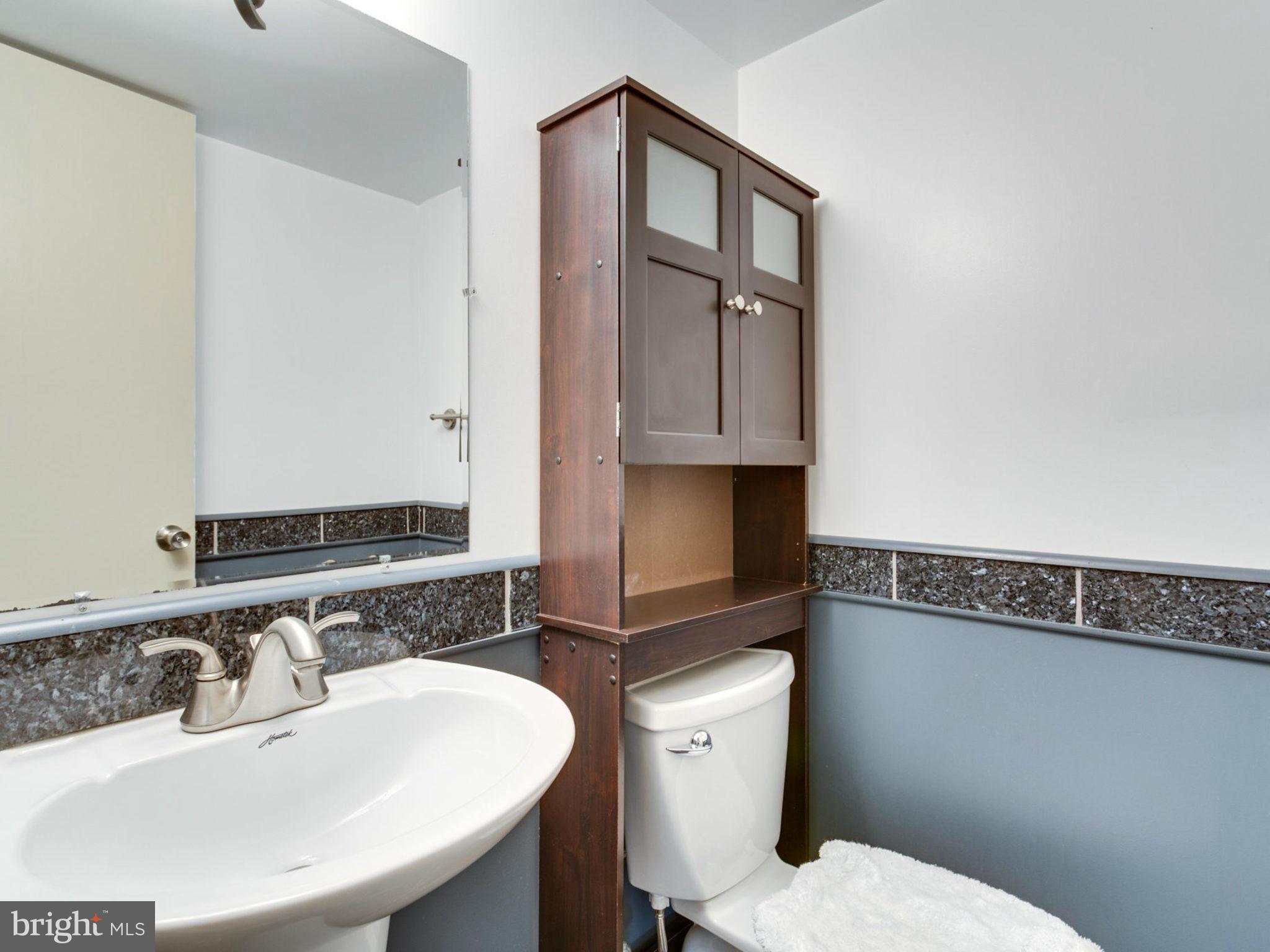 415 Rockway Road Catonsville, MD 21228 - Photo 22 of 30 a bathroom with a sink a toilet and mirror